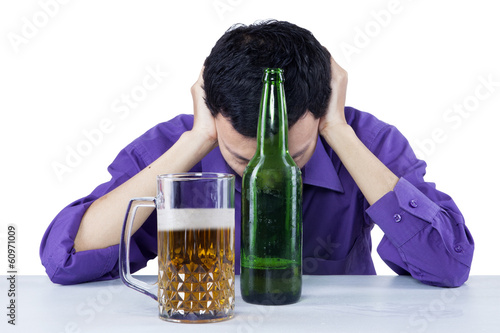Photo: Sad drunk businessman with beer Sad drunk businessman with beer