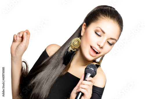 Photo: Singing Woman. Beauty Woman with Microphone Singing Woman. Beauty Woman with Microphone