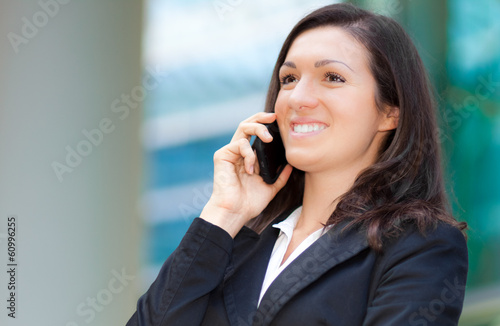 Photo: Smiling businesswoman at the phone Smiling businesswoman at the phone