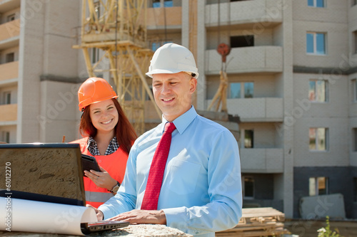 Photo: White-collar workers works on the building site White-collar workers works on the building site