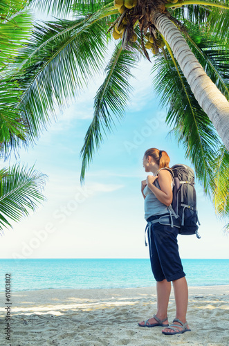 Photo: Young female backpacker on a beach Young female backpacker on a beach