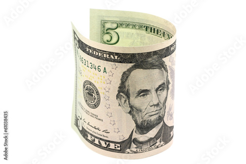 Photo: Five dollars rolled in a roll on a white background Five dollars rolled in a roll on a white background