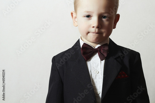 Photo: Handsome Little Boy in Black Suit.Stylish Child with Blue Eyes Handsome Little Boy in Black Suit.Stylish Child with Blue Eyes