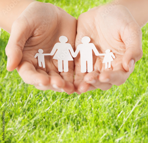 Photo: female hands with paper man family female hands with paper man family