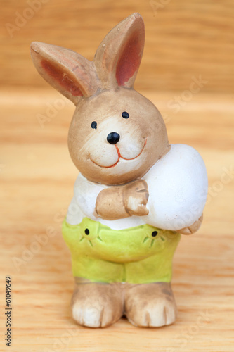 Photo: Easter time. Ceramic rabbit with a egg Easter time. Ceramic rabbit with a egg