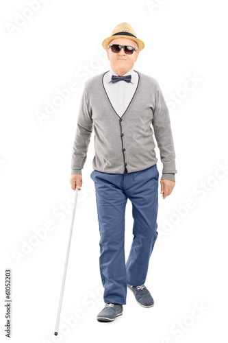 Photo: Blind senior gentleman walking with a stick Blind senior gentleman walking with a stick