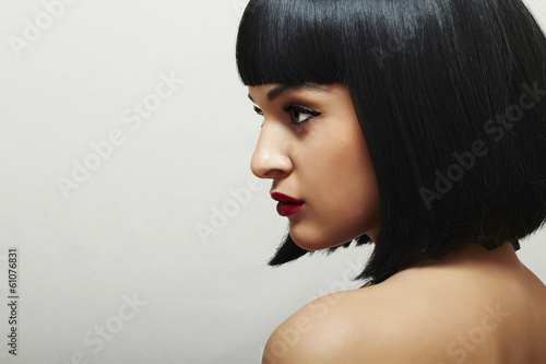 Photo: Beautiful Brunette Woman.Healthy Black Hair.Retro Haircut Beautiful Brunette Woman.Healthy Black Hair.Retro Haircut
