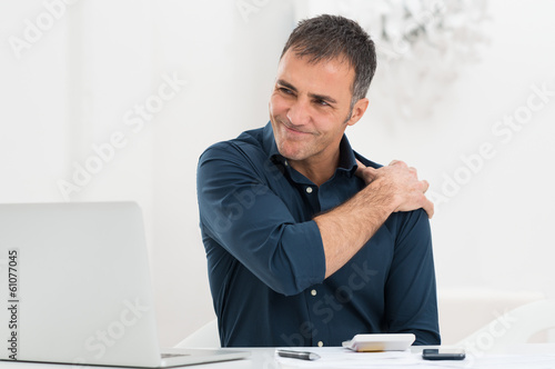 Photo: Businessman Suffering From Shoulder Pain Businessman Suffering From Shoulder Pain