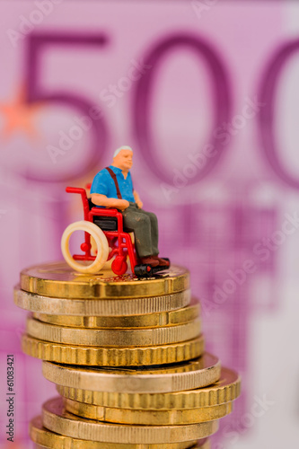 Photo: woman in wheelchair on money stack woman in wheelchair on money stack