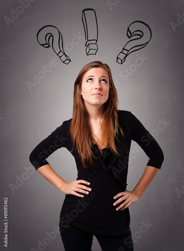 Photo: Young lady thinking with question marks overhead Young lady thinking with question marks overhead