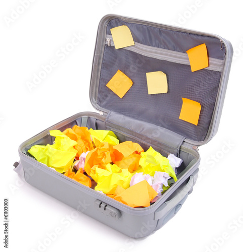 Photo: Open suitcase with paper stickers isolated on white Open suitcase with paper stickers isolated on white