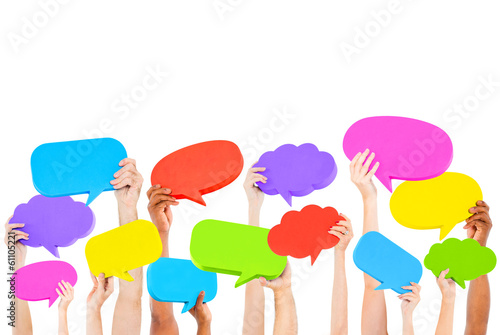 Photo: Hands holding multi colored speech bubbles Hands holding multi colored speech bubbles