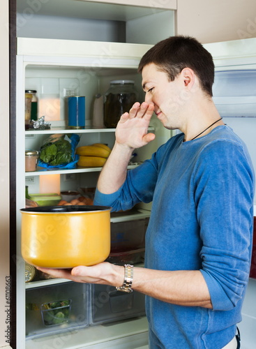 Photo: Hungry man holding foul food Hungry man holding foul food