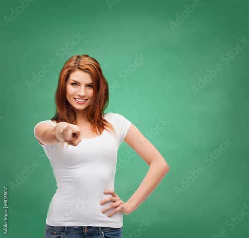 Photo: teenager in blank white t-shirt pointing at you teenager in blank white t-shirt pointing at you