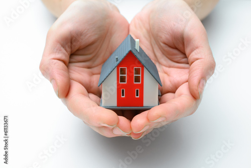 Photo: house in human hands house in human hands
