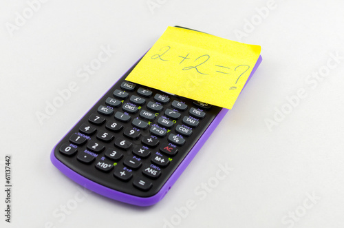 Photo: Calculator and yellow sticky note on the calculator Calculator and yellow sticky note on the calculator