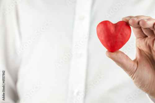 Photo: Man holding a romantic red heart Man holding a romantic red heart