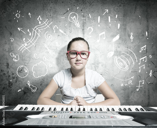 Photo: School girl with piano School girl with piano