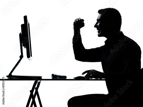 Photo: one business man silhouette computer computing happy one business man silhouette computer computing happy