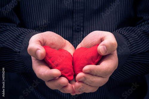Photo: two red hearts held male hands two red hearts held male hands