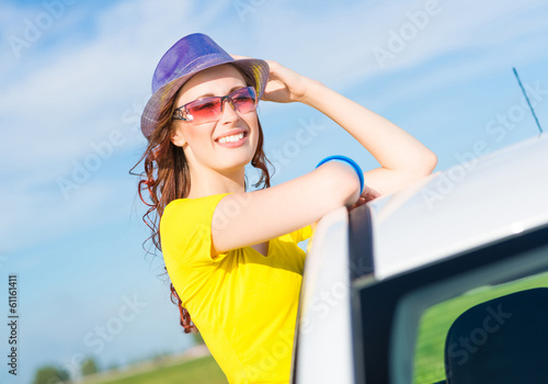Photo: Young woman got out of car window Young woman got out of car window