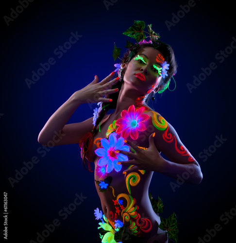 Photo: Sexy woman posing with painted flowers on her body Sexy woman posing with painted flowers on her body