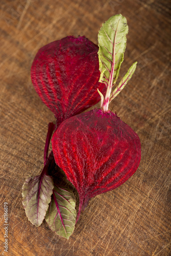 Photo: beet with leaves on a wooden background beet with leaves on a wooden background