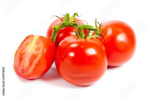 Photo: Closeup of tomatoes on the vine isolated on white. Tomato branch Closeup of tomatoes on the vine isolated on white. Tomato branch