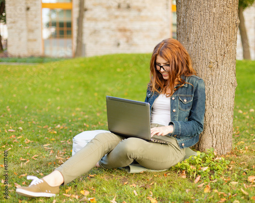 Photo: smiling teenager in eyeglasses with laptop smiling teenager in eyeglasses with laptop