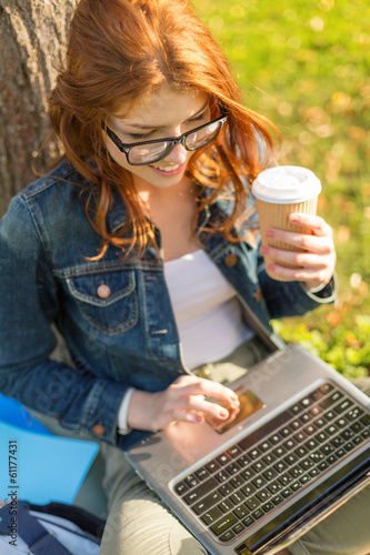 Photo: teenager in eyeglasses with laptop and coffee teenager in eyeglasses with laptop and coffee