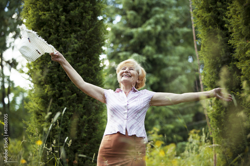 Photo: Freedom. Old Lady with Hut smiling in The Garden. Lifestyle Freedom. Old Lady with Hut smiling in The Garden. Lifestyle