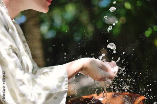 Photo: splashing fresh water on woman hands splashing fresh water on woman hands