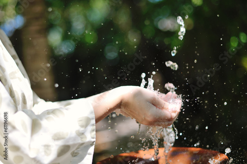 Photo: splashing fresh water on woman hands splashing fresh water on woman hands