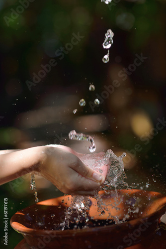 Photo: splashing fresh water on woman hands splashing fresh water on woman hands