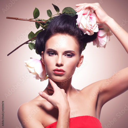 Photo: Portrait of beautiful young woman with flowers in hair. Portrait of beautiful young woman with flowers in hair.