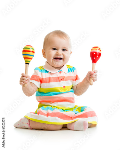 Photo: Baby girl playing with musical toys. Isolated on white backgroun Baby girl playing with musical toys. Isolated on white backgroun