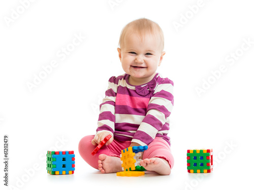 Photo: kid playing toy blocks isolated on white background kid playing toy blocks isolated on white background