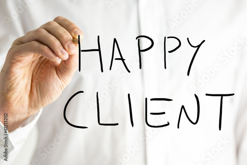 Photo: Man writing Happy Client on a virtual screen Man writing Happy Client on a virtual screen