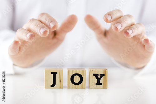 Photo: Mans hands cupped over the word Joy Mans hands cupped over the word Joy