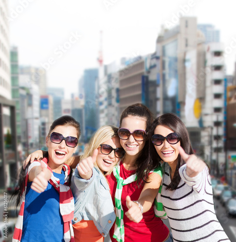 Photo: teenage girls or young women showing thumbs up teenage girls or young women showing thumbs up