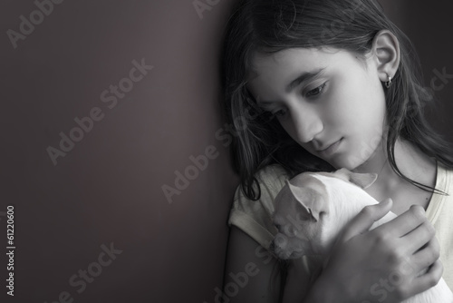 Photo: Sad and lonely girl and her small dog Sad and lonely girl and her small dog