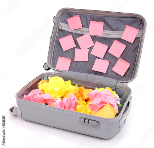Photo: Open suitcase with paper stickers isolated on white Open suitcase with paper stickers isolated on white