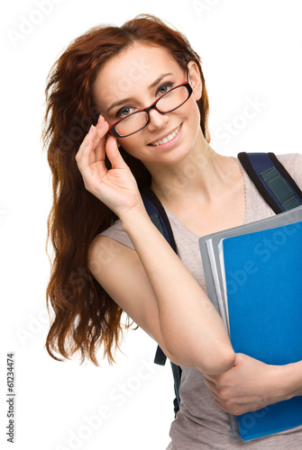 Photo: Young student girl is holding book Young student girl is holding book