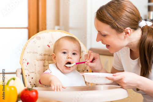 Photo: Mom feeds baby with spoon Mom feeds baby with spoon