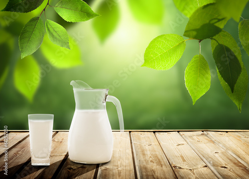Photo: milk on table and sunny trees milk on table and sunny trees