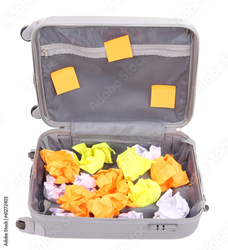 Photo: Open suitcase with paper stickers isolated on white Open suitcase with paper stickers isolated on white