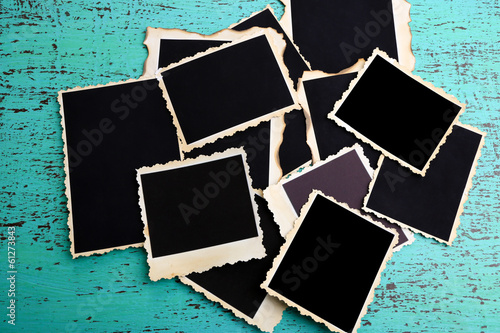 Photo: Blank old photos on color wooden background Blank old photos on color wooden background