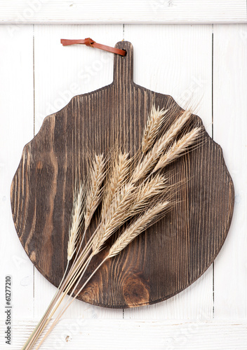 Photo: Wheat ears on vintage board Wheat ears on vintage board