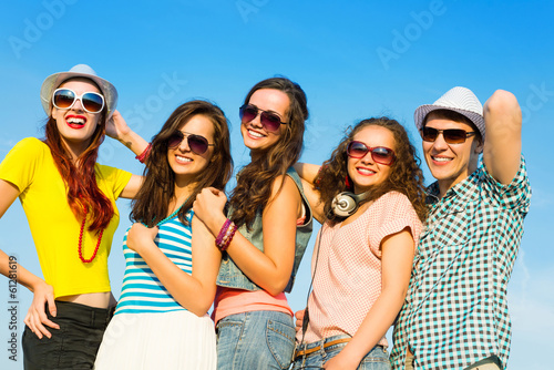 Photo: group of young people wearing sunglasses and hat group of young people wearing sunglasses and hat