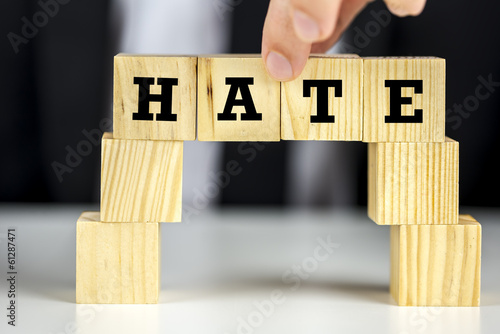 Photo: Bridge of cubes with word hate written on them Bridge of cubes with word hate written on them
